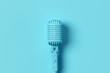 Retro style vintage blue microphone on blue background.