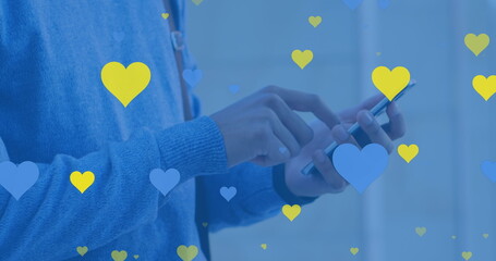 Poster - Biracial young adult male holding smartphone, surrounded by hearts