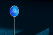 Bicycle lane traffic sign on the street against the dark blue wall