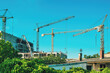 Tall cranes on residential building construction site