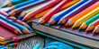 A variety of school supplies lying on the table. A close-up banner