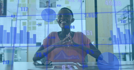 Poster - African American professional in pink shirt sits behind data screens