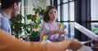 Multiple rainbow heart icons floating over group of diverse office colleagues discussing at office