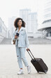 Woman tourist with suitcase luggage standing in a city, Smiling mixed race girl going on travel, Business travel, student lifestyle, people, tourism concept