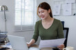 © David - Young Asian business woman working on a laptop doing tax, accounting, statistics and analytical research concept.
