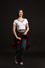 Poster - Full length portrait of smiling tattooed woman on black background