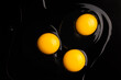 Egg yolks on black background . Top view