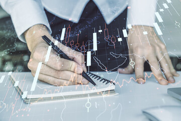 Poster - Multi exposure of abstract creative financial chart with world map and with hand writing in notebook on background with laptop, research and analytics concept