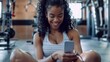 © Marta B - Smiling Woman with Smartphone at Gym