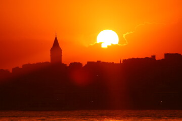 Wall Mural - Galata Tower view at sunset with sun behind the clouds