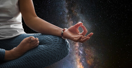 Wall Mural - Woman meditating with the universe in the background