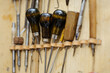 Tools and leather at cobbler workplace. Set of leather craft tools on wooden background.