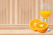 Orange juice in a glass and slices of orange fruit on a wooden table. Healthy food concept.