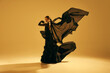 © master1305 - Artistic and expressive performance. Young woman, ballet dancer in black flowing attire dancing against golden background. Concept of art, classical dance, beauty and fashion, aesthetics