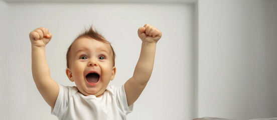 a baby is smiling and holding up his arms in the air. baby is happy and excited. a cute baby's delig