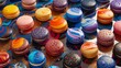 An array of vibrant macarons with a mixture of colors and textures on a glossy background