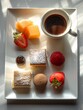 Elegantly arranged breakfast with mango, pastries, strawberries, and coffee on a white plate in sunlight