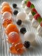 An elegant display of spherical desserts with vibrant orange and black textures placed in a neat row