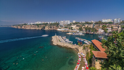 Wall Mural - Aerial view of yacht harbor and red house roofs in Old town timelapse Antalya, Turkey.