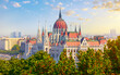 Panorama with Budapest Hungarian Parliament building at Danube river in city, Hungary. Scenic summer panoramic view. Green trees and blue dramatic sky clouds. Europian capital city