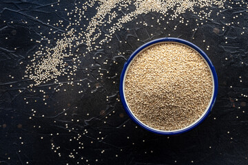 Wall Mural - Quinoa in a bowl, healthy organic wood, uncooked, shot from above with a place for text