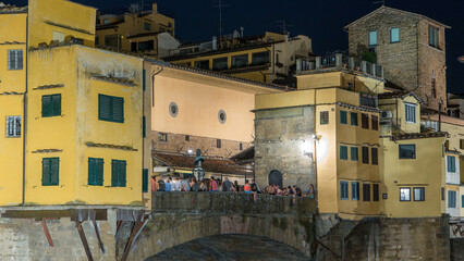 Poster - Famous Ponte Vecchio bridge over the Arno river timelapse in Florence, Italy, lit up at night