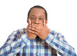 young man covering his mouth with hands