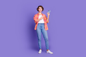 Poster - Full size photo of pretty young girl point finger smart phone wear shirt isolated on violet color background