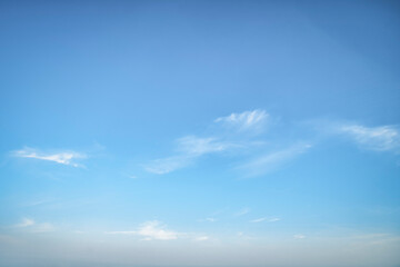 Wall Mural - Clear blue sky. Light background with small white clouds.