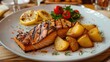 grilled salmon with potatoes on a white plate. Selective focus