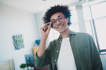 Poster - Photo of handsome cool assistant dressed khaki shirt hand arm glasses smiling indoors workstation workplace