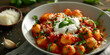 Potato gnocchi in tomato sauce with basil and parmesan and a glass of white wine on blue background,Traditional Italian potato Gnocchi with tomato sauce and fresh basil with glas of white wine. rustic