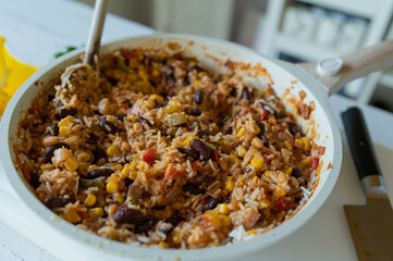 Wall Mural - Healthy rice dish with ham, kidney beans, corn, peppers, onions, tomatoes and herbs. Low fat and high protein dinner or luch in a frying pan