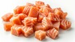 © NAPATSAWAN - A pile of fresh, raw salmon cubes on a white background.
