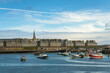 Cityscape of Saint-Malo with colorful fishing boats in the port and the historic walled city in the background,  Ille-et-Vilaine, Brittany, France