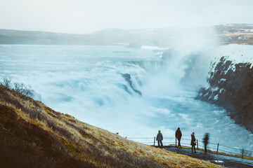 tourist visit stand on viewpoint gullfoss waterfall in iceland, cinematic beautiful majestic winter 