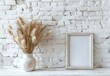 Minimalistic Mockup Frame on White Brick Background. Wheat in a Vase Decoration. Empty Frame Mockup.