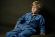 © juliars - Practical Modern child underground bunker. Blue jumpsuit. Generate Ai