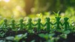 © Suparak - Little green people holding hands in a green park Environmental team for agriculture