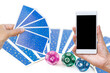Tarot card and smartphone in girl hand over blurred tarot card and astrological dice background, online fortune telling, tarot reading 