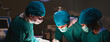 © bigy9950 - Group of concentrated surgical doctor team doing surgery patients in hospital operating theater. Professional medical team doing critical operations.