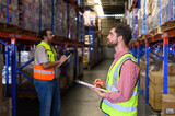 Fototapeta Niebo - Warehouse worker in safety uniform check the stock order details and goods supplies in the workplace warehouse. industry logistic export import distribution concept.