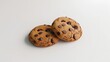 Two chocolate chip cookies on a white background