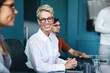 © Jacob Lund - Mature woman smiling at the camera in a business meeting