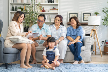 Real estate woman agent holding contract to buy and sell and life insurance to family for signature, consultant talk in house for sale.asian father signing contract.business and real estate concept