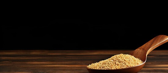 Canvas Print - A wooden table serves as the backdrop for a copy space image featuring a spoonful of natural sesame seeds