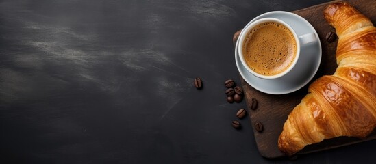 Sticker - Top view copy space image of a delicious croissant and a steaming cup of coffee on a gray background creating a perfect breakfast concept