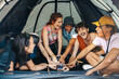 © Jacob Lund - Group of festival goers having fun during a drinking game in a tent
