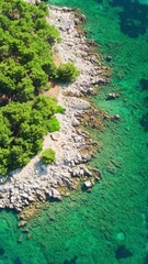 Wall Mural - Aerial view of the stunning Adriatic coast with turquoise sea water in the Dalmatia region, Croatia. A small boat is peacefully moored in the beautiful sea bay. Travel vacation concept