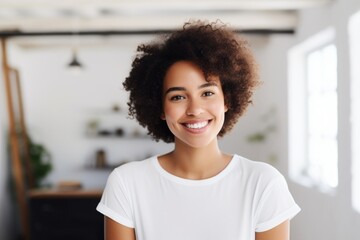 Sticker - Portrait of a tender afro-american woman in her 20s smiling at the camera while standing against modern minimalist interior